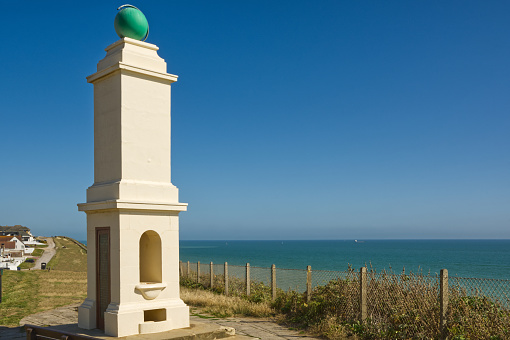 King George V. Memorial marking prime meridian of Greenwich dated 1936. At Peacehaven in East Sussex, England. With English Channel behind.