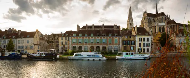 View of Auxerre cityscape with Saint-Germain Abbey on river Yonne on cloudy autumn day, Burgundy, France