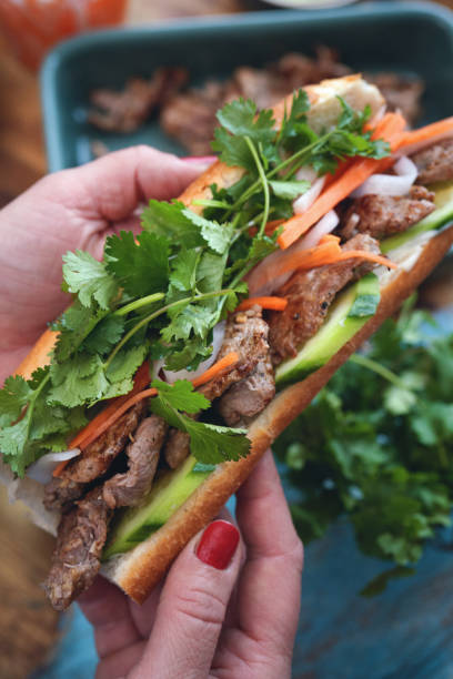 istock Preparing Thai Baguette Sandwich with Beef, Carrots, Cucumber and Cilantro 1346411966