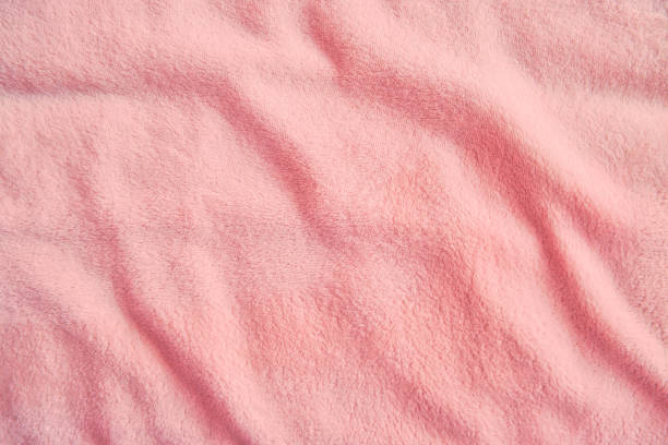 istock Fluffy gentle pastel pink fabric with waves and folds. Soft pastel textile texture. 1346413607