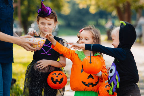 istock Three kid with a basket for sweets gets candies 1346413701