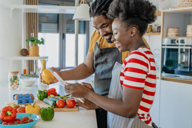 istock Young couple cooking together in the kitchen 1346414563