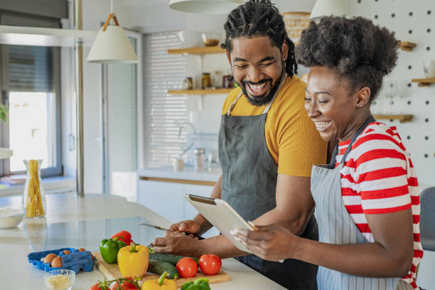 istock Young couple cooking together in the kitchen 1346414704