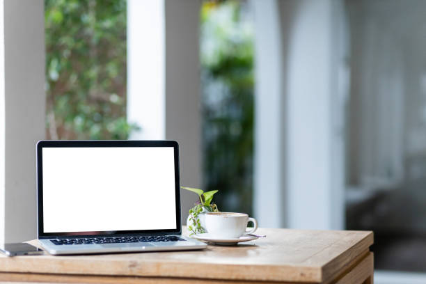 istock Mockup of laptop computer with empty screen with coffee cup and smartphone on table of the coffee shop background,White screen 1346414856