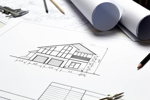 istock Architectural drawing of a house on a designer's desktop. Blueprints. 1346415657