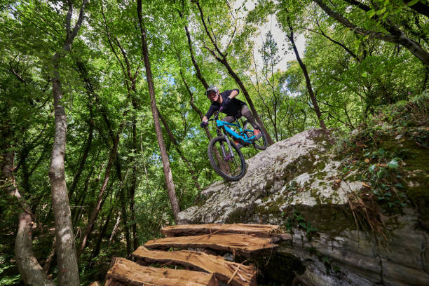 istock Enduro biker on a challenging self constructed trail in the woods 1346415857