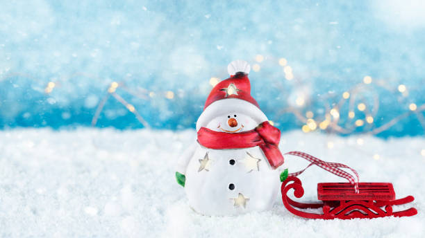 istock Happy snowman with red sleigh 1346420689
