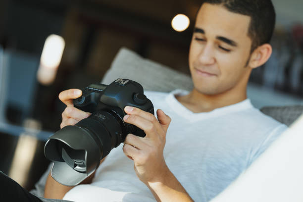 istock Young Black photographer chimping his photo on his camera 1346422379