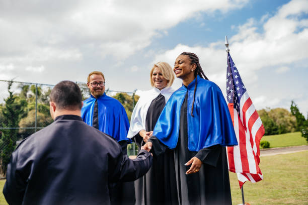 istock Teachers greeting a graduate outdoors 1346422667