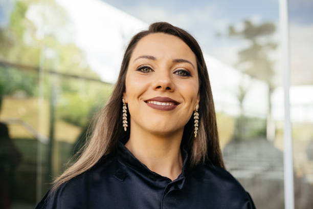 Portrait of a smiling graduate woman outdoors Portrait of a smiling graduate woman outdoors drop earring stock pictures, royalty-free photos & images