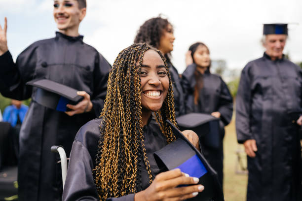 istock Smiling graduates at outdoor ceremony 1346422699