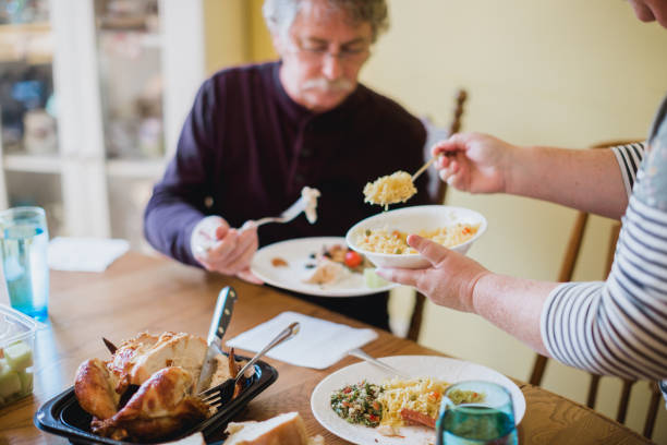 istock Family Gathering At Table for A Meal Together 1346423654