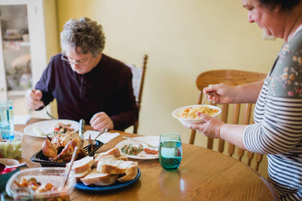 istock Family Gathering At Table for A Meal Together 1346423669