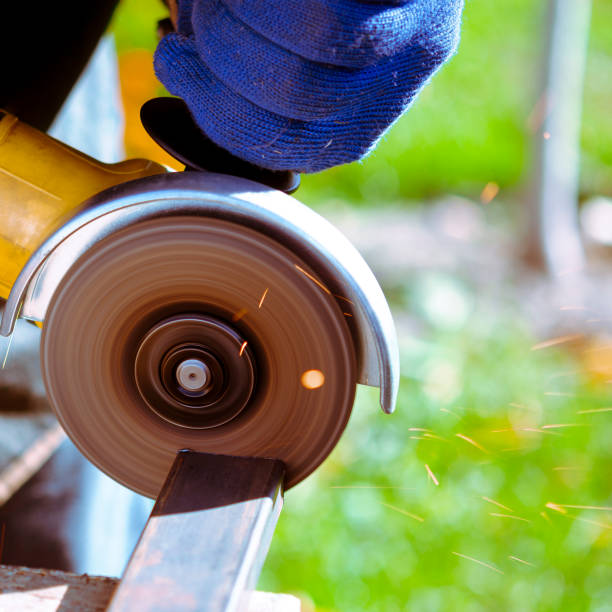 istock Heavy industry worker cutting steel with angle grinder at car service 1346424804