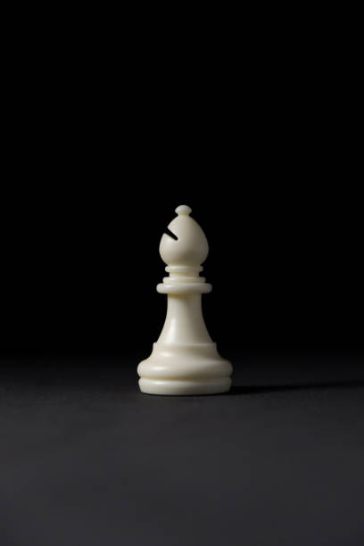 istock isolated white bishop chess piece on black background 1346425229
