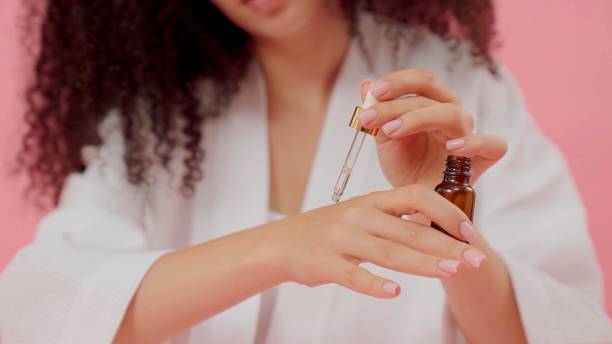 istock woman is using a beauty product 1346431162