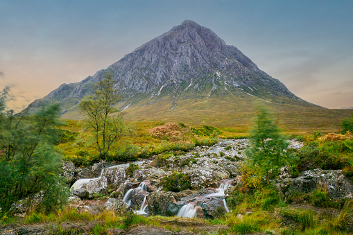 A long exposure of the waterfall and river near the mountain Buachaille Etive Mor at Glencoe in Scotland, taken at dusk.