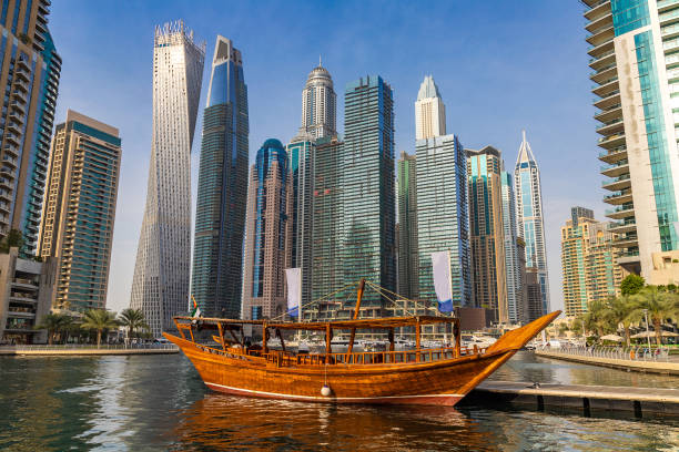 Dhow cruise in Dubai Marina Old wooden ship, Dhow cruise in Dubai Marina, Dubai, United Arab Emirates dhow photos stock pictures, royalty-free photos & images