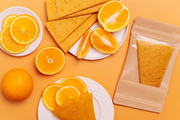 Fruit Orange pastille on orange background.Natural sweets from fruits.Close-up mix sliced.Vegetarian lifestyle.Healthy breakfast. Sweet and healthy food, snacks.Diet vitamin food and vegan food. pastel de naranja fruta sobre fondo naranja. desayuno saludable. dulces naturales a partir de frutas. mezcla de primer plano en rodajas. estilo de vida vegetariano. comida dulce y saludable, snacks. dieta de alimentos vitamínicos y alimentos veganos.