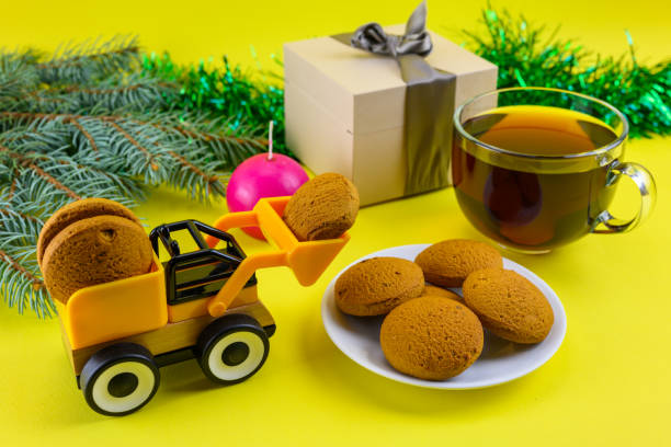 A toy excavator delivers cookies to celebrate children's Christmas. stock photo