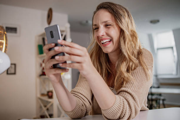 istock Woman at home, smiling and using smart phone 1346436277