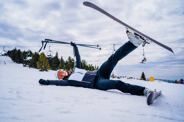 istock Skier woman lying in the snow 1346438695