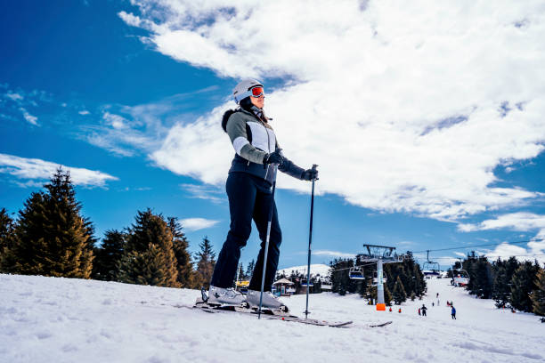 istock Young active woman skiing in mountains 1346439757