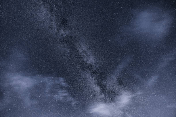 istock milky way on a partly cloudy sky in monochrome 1346441693