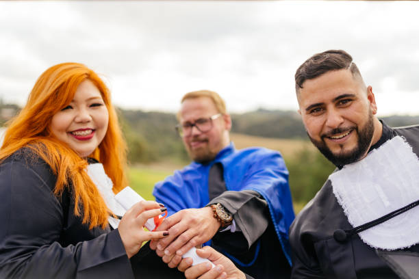 Smiling teacher and students at graduation