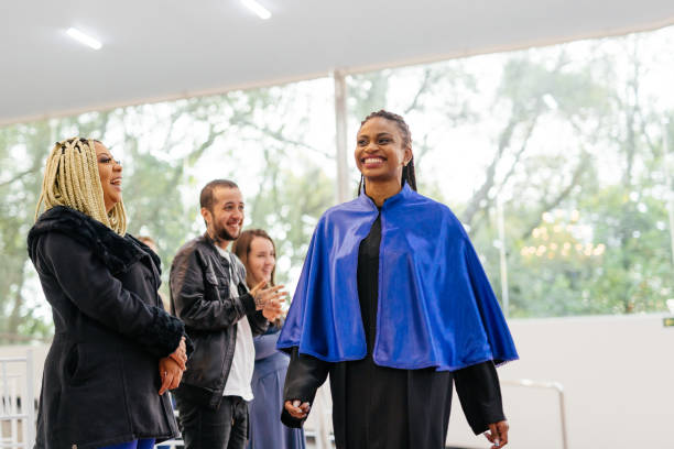istock Teacher and applause at graduation 1346443456