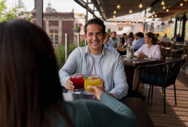 istock Happy man on a date having drinks and making a toast 1346447934