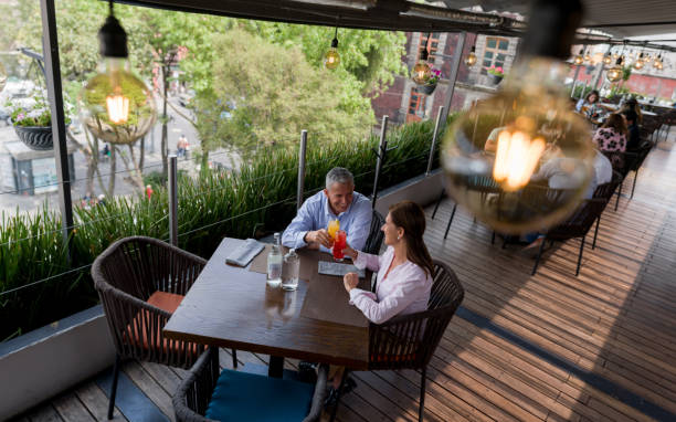 istock Couple having drinks at a restaurant and making a toast 1346447946