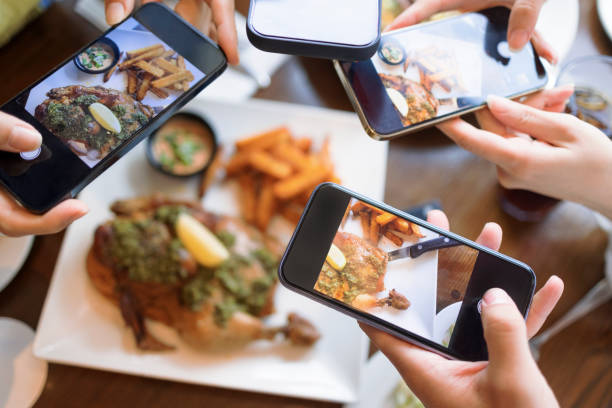 istock Group of friend taking  picture with smart phone before dinner. top view. 1346447979