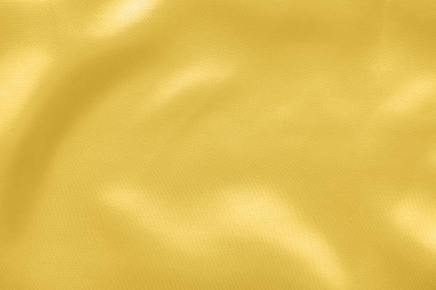 istock Abstract luxury gold fabric with soft wave texture background 1346449039
