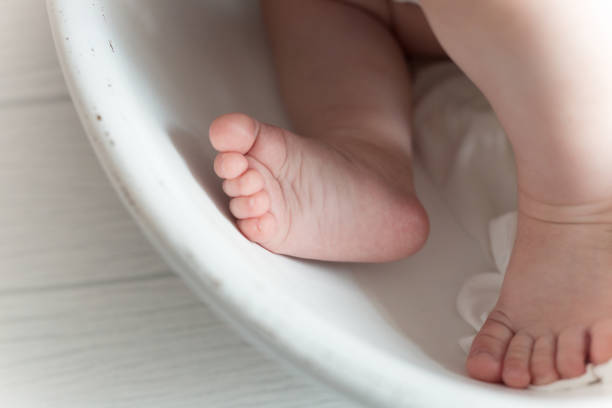 istock Little infant's feet in a white bowl 1346449429