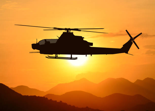 istock American attack helicopter silhouette in the flight 1346450518