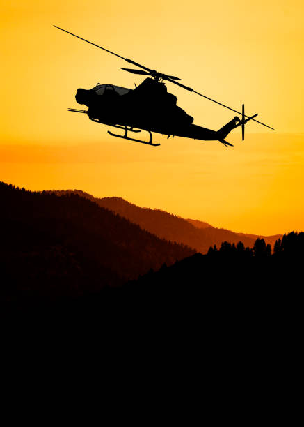 istock American attack helicopter silhouette in the flight 1346450520