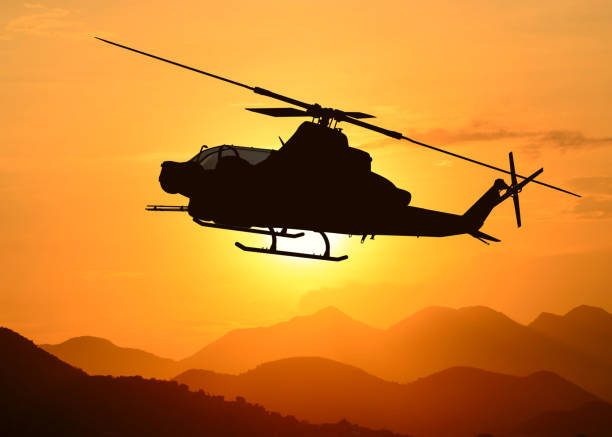 istock American attack helicopter silhouette in the flight 1346450522