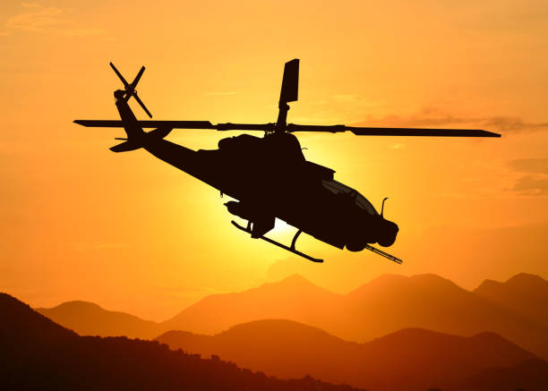 istock American attack helicopter silhouette in the flight 1346450527
