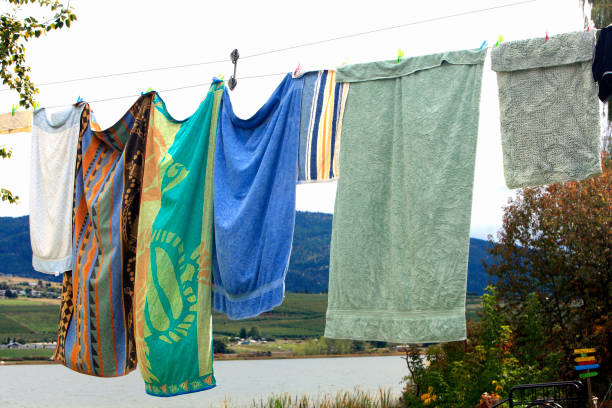 Wash of Towels drying on an old fashioned clothes line. Lake below.