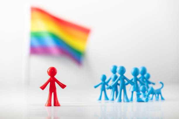 istock Plastic figure, LGBT rainbow flag and heterosexuals on light gray background 1346453669