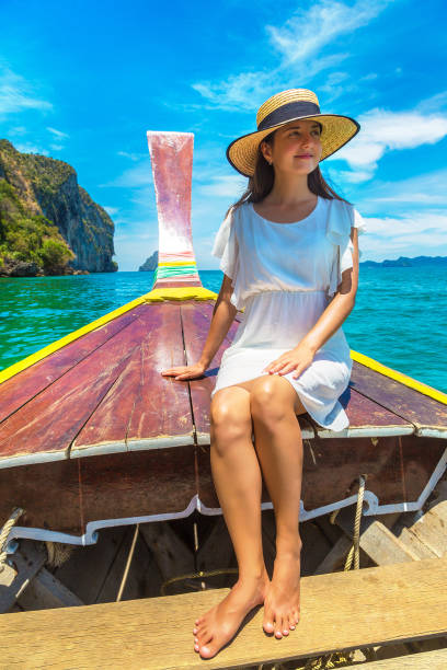 istock Woman on boat in Thailand 1346455580