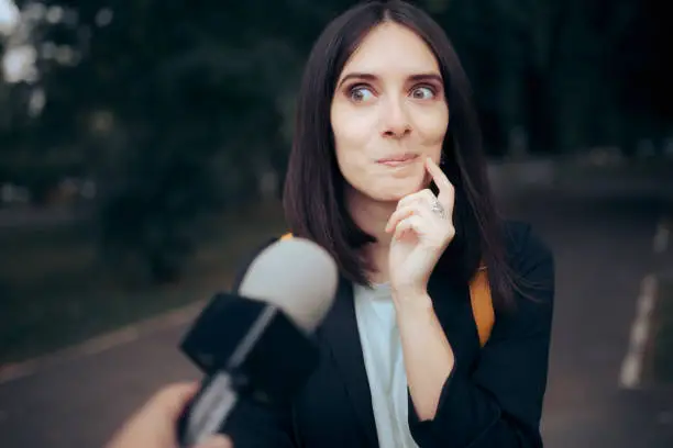 Woman being interviewed by a reporter in vox pop video format