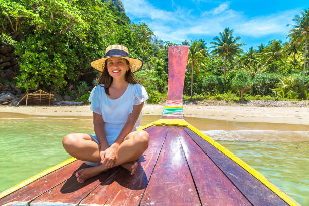 istock Woman on boat in Thailand 1346455636