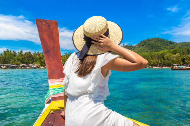 istock Woman on boat in Thailand 1346455645