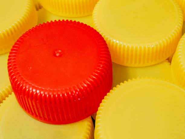 istock Yellow plastic caps and one red. Recycling concept 1346458771