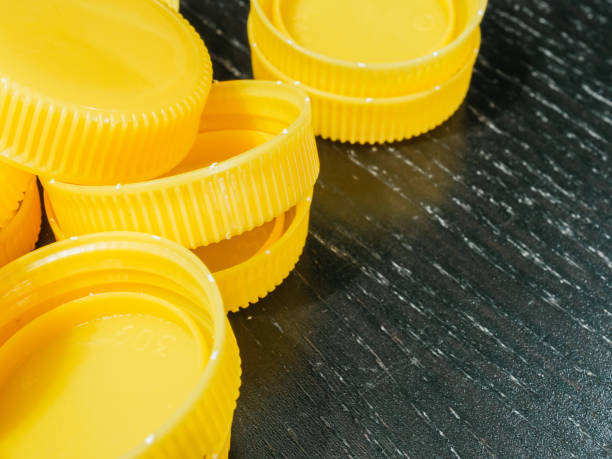 istock Yellow plastic caps with copy space. Recycling concept 1346458783