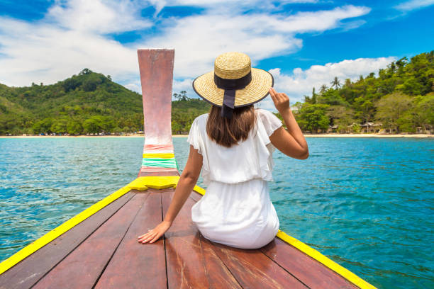 istock Woman on boat in Thailand 1346459620