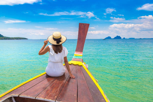 istock Woman on boat in Thailand 1346459624