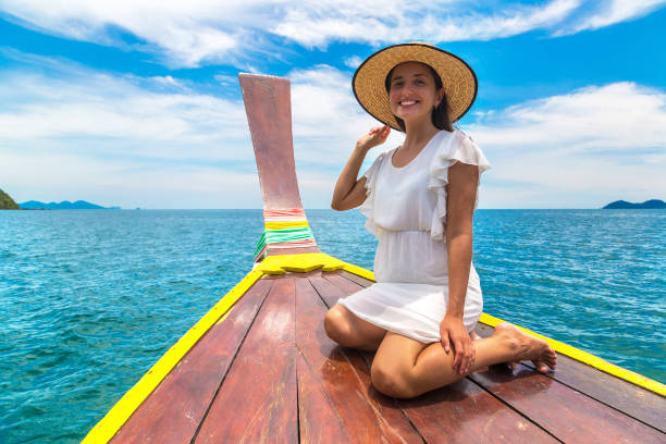 istock Woman on boat in Thailand 1346459673